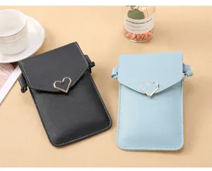 Detail view of the stylish crossbody phone bag with heart lock, clear touch screen pocket.