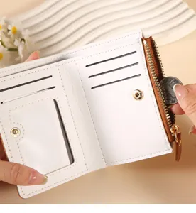 Close-up detail of women short white wallet featuring multiple card slots and zipper pocket.