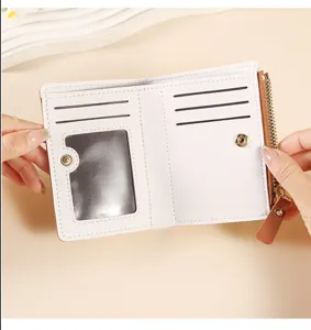Compact white and brown bifold wallet detail showing card slots, ID window and zipper pocket.