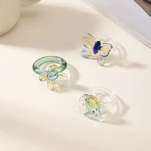 Handmade glass butterfly and flower rings set, exquisite detailed view for summer beach vacation.