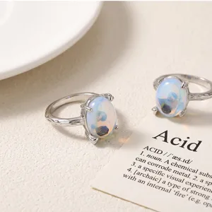 Detail shot of colorful imitation moonstone ring, showing textured silver band and opal glass.