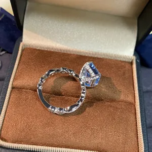 Close-up detail of sterling silver ring featuring large blue aquamarine and sparkling pave setting