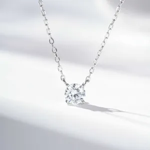 Close-up detail of a classic four-prong solitaire pendant necklace with a brilliant cut stone.