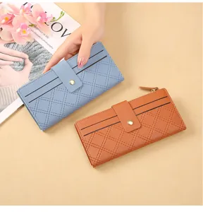Details of new women long wallet with diamond quilting, snap button, zipper and card slots.