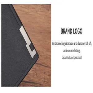 Men's wallet metal corner detail close-up showing embedded design and black leather texture.
