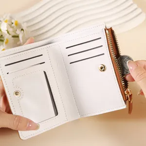 Compact women's bifold wallet with card slots, ID window, and zipper coin pocket, white.