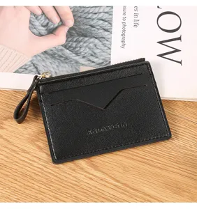 Detailed view of black leather card holder featuring secure zipper and multiple card slots.
