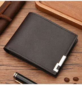 Men's short leather wallet detail view showcasing premium brown texture and metal corner decor.