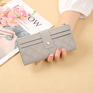 Grey long wallet for women with card slots, snap button closure and stylish quilted design.
