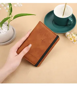Brown PU leather passport holder wallet with elastic band for travel document organizer.