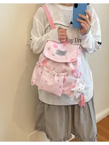 Vue détaillée de sac à dos rose imprimé d'étoiles, cartable mignon style doux avec pendentif.