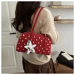Red polka dot shoulder pillow bag detail with cute silver star pendant and twin handles.