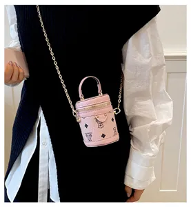 Detailed shot of the pink mini bucket bag featuring cute monogram and metallic chain.