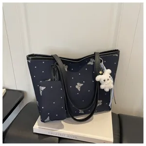 Casual commuting tote bag for women with glitter butterfly print and cute puppy keychain detail.