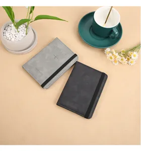 Detail view of PU leather passport holder with elastic band in grey and black color.