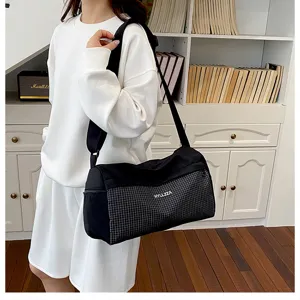 Large capacity travel duffel bag for women, casual grid shoulder bag for gym and short trips.
