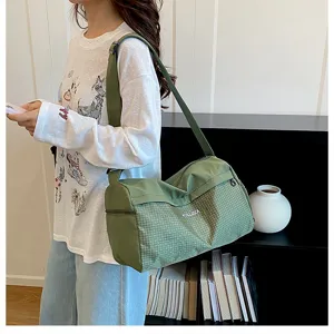 Large capacity green travel duffel bag for women, lightweight gym and weekend overnight bag.