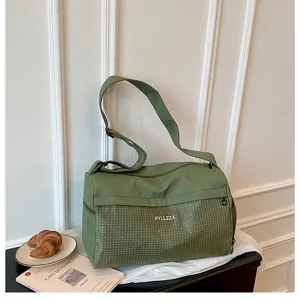 Green large capacity travel duffel bag detail, portable fitness and weekend bag for women.