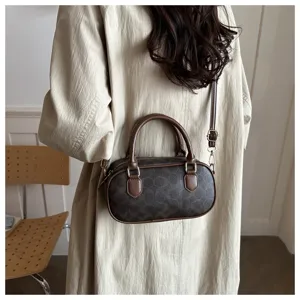 Retro brown monogram barrel pillow bag, stylish shoulder crossbody handbag for women.