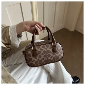 Vintage brown monogram bowling bag, classic top handle pillow bag, stylish shoulder bag.