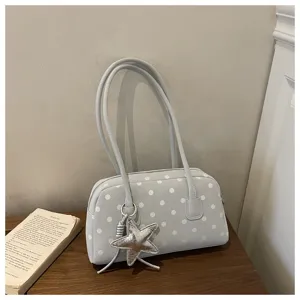 Cute polka dot pillow shoulder bag detail shot, featuring stylish star pendant and double straps.