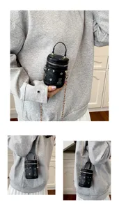 Mini black cylindrical bucket bag with metal chain strap and cute cartoon bear print for kids.