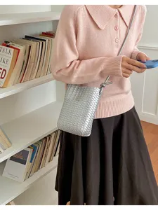 Detailed view of the stylish silver woven phone bag, showing the intricate PU leather texture.