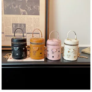 Mini cute bucket bag with handle and chain, stylish children accessory in multiple colors.