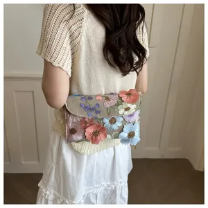 Detailed view of the floral embroidered shoulder bag showing exquisite craftsmanship and chain strap.
