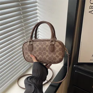 Vintage retro brown monogram bowling handbag with top handles and adjustable shoulder strap.