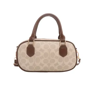 Vintage monogram pillow handbag for women, stylish bowling shoulder bag with top handle.