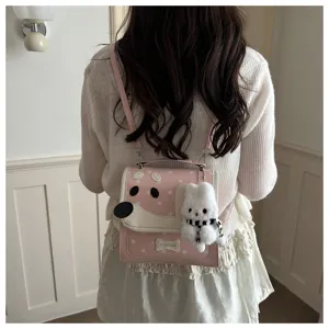 Cute pink cartoon dog backpack detail with star print and fluffy rabbit plush pendant design.