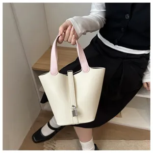 Minimalist two-tone bucket bag with padlock accent, chic casual handbag for women daily wear.