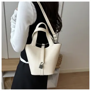 Fashionable solid color bucket bag with padlock design, elegant leather shoulder bag for women.