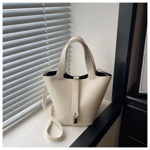 Minimalist solid color leather bucket bag for women, chic shoulder crossbody handbag.