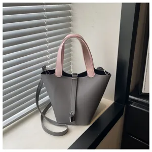 Chic solid color bucket bag for women, stylish shoulder bag with lock and dual handles.