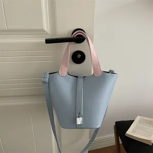 Chic leather bucket bag for women, stylish solid color shoulder bag with top handles.