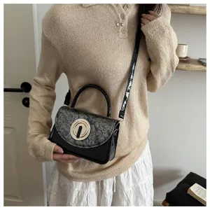 Detailed view of the stylish women crossbody bag showing glossy finish and metal ring lock.