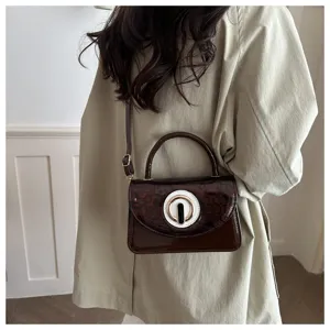 Stylish mini patent leather shoulder bag with chic round clasp detail for daily fashion wear.
