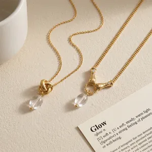 Gold crystal clavicle chain necklace featuring elegant hand clasp and knot design pendants.