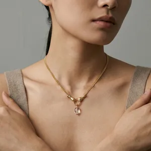 Gold clavicle chain necklace featuring a natural white crystal pendant and double hand clasp design.