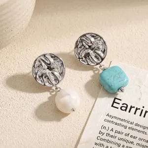 Asymmetric metal earrings featuring white pearl and turquoise stone, niche luxury design.