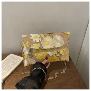 Detailed close-up of stylish floral embroidered chain evening shoulder bag for women.