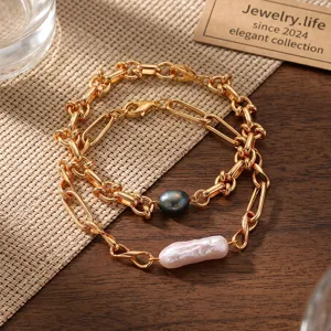 Detail shot of double-layer gold chain bracelets featuring freshwater pearls on wooden background.