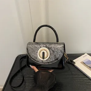 Stylish mini patent leather shoulder bag with round clasp and handle for fashion women girls.