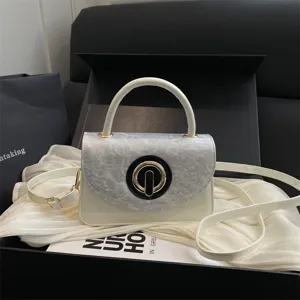 Small white crossbody bag for women, stylish marble pattern flap shoulder handbag with chic clasp.