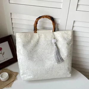 Sac à main pour femme de style chinois avec poignée en bambou et charmant gland élégant.