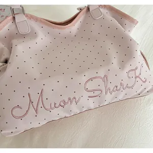 Pink polka dot tote bag detail view, casual large capacity shoulder bag for daily commuting.