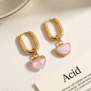 Detailed close-up shot of elegant gold hoop earrings featuring natural pink crystal charms.
