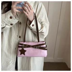 Stylish pink shoulder bag for women with brown straps and star pendant for daily wear.